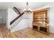 Light-filled dining area with an antique hutch, modern chandelier, staircase and hardwood flooring at 4638 S Mobile Way, Aurora, CO 80015