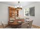 Dining room with elegant chandelier, wooden hutch, hardwood floors, and set dining table at 4638 S Mobile Way, Aurora, CO 80015