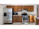 A kitchen featuring stainless steel appliances and wood cabinetry at 4638 S Mobile Way, Aurora, CO 80015