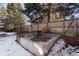 Concrete patio featuring a wooden bench and wooden box, enclosed by a wooden fence at 4638 S Mobile Way, Aurora, CO 80015