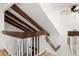 Stairway with wooden beams and a view of a cozy fireplace at 4638 S Mobile Way, Aurora, CO 80015