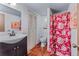 Bathroom featuring a single sink vanity, toilet and shower with curtain at 18771 Mexico E Dr, Aurora, CO 80017