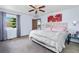 Bright bedroom with a soft carpet, ceiling fan and a window at 18771 Mexico E Dr, Aurora, CO 80017
