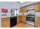 Charming kitchen with wood cabinets, stainless steel appliances, and modern features at 18771 Mexico E Dr, Aurora, CO 80017
