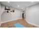 Finished basement with a home gym area featuring cork flooring, neutral paint, a window, and fitness equipment at 8827 Cactus Flower Way, Highlands Ranch, CO 80126