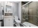 Modern bathroom featuring a vanity with a stone countertop, a framed mirror, and glass-enclosed shower at 8827 Cactus Flower Way, Highlands Ranch, CO 80126