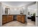 Well-lit bathroom with a double vanity and wood cabinets, offering ample storage at 8827 Cactus Flower Way, Highlands Ranch, CO 80126