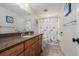 Bathroom featuring a vanity with granite countertop, wood cabinets, and a shower with a decorative curtain at 8827 Cactus Flower Way, Highlands Ranch, CO 80126