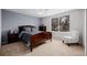 Traditional bedroom with a dark wood bed frame, a ceiling fan, and a window at 8827 Cactus Flower Way, Highlands Ranch, CO 80126