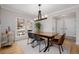 Stylish dining room with a wood table, modern chairs, and a chic light fixture, perfect for entertaining at 8827 Cactus Flower Way, Highlands Ranch, CO 80126