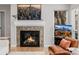 Close-up of a decorative fireplace with a patterned tile surround, set in a bright living room with hardwood floors at 8827 Cactus Flower Way, Highlands Ranch, CO 80126