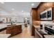 Kitchen with dark wood cabinetry, stainless steel appliances, and views to a breakfast nook and the back yard at 8827 Cactus Flower Way, Highlands Ranch, CO 80126