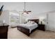 Spacious main bedroom featuring high ceilings, a ceiling fan, and a sitting bench at 8827 Cactus Flower Way, Highlands Ranch, CO 80126