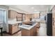 Modern kitchen with light wood cabinets, quartz countertops, and an island at 11759 E Asbury Ave, Aurora, CO 80014