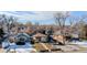 Aerial view of a house on a tree-lined street in a snow-covered neighborhood at 4631 Zuni St, Denver, CO 80211