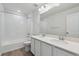 Modern bathroom features a double sink vanity with white cabinets and sleek fixtures, plus a shower at 9062 Telluride Ct, Commerce City, CO 80022