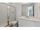 Bright bathroom featuring a glass enclosed shower, modern vanity with quartz countertop, and white cabinets at 9062 Telluride Ct, Commerce City, CO 80022