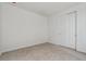 Clean, empty bedroom with a carpeted floor, white walls, and a double door closet at 9062 Telluride Ct, Commerce City, CO 80022