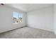 Bright, carpeted bedroom featuring a large window with a view at 9062 Telluride Ct, Commerce City, CO 80022