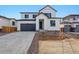 Modern two-story home with a gray garage door, newly landscaped front yard, and a welcoming entryway at 9062 Telluride Ct, Commerce City, CO 80022