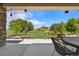 Covered patio has a table and chairs with a scenic view of the golf course at 4960 Malaya St, Denver, CO 80249