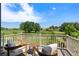 Relaxing balcony seating with beautiful green golf course and tree views in the background at 4960 Malaya St, Denver, CO 80249