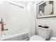 Modern bathroom featuring a white tub, white tile and a window for natural light at 4960 Malaya St, Denver, CO 80249
