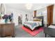 Stylish bedroom featuring a gray bed, wood dresser and warm, natural light at 4960 Malaya St, Denver, CO 80249