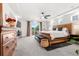 Bright main bedroom boasts a spacious layout, large windows, and private balcony access at 4960 Malaya St, Denver, CO 80249