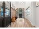 Elegant foyer features high ceilings, wood floors, stylish decor, coat rack, and a well-lit and welcoming entryway at 4960 Malaya St, Denver, CO 80249