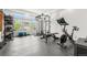 A well-equipped home gym with various weight machines, free weights, and large bright windows at 4960 Malaya St, Denver, CO 80249
