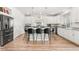 Modern kitchen featuring a large island with bar seating, granite countertops, and stainless steel appliances and fixtures at 4960 Malaya St, Denver, CO 80249