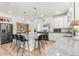 Bright kitchen featuring a large kitchen island with barstool seating and stainless steel appliances and a walk-in pantry at 4960 Malaya St, Denver, CO 80249