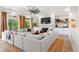 Cozy living room with a white brick fireplace, built-in shelving, and a large sectional sofa for relaxing at 4960 Malaya St, Denver, CO 80249