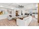 Open-concept living room flows to kitchen with an inviting sectional sofa, stylish décor and excellent natural light at 4960 Malaya St, Denver, CO 80249