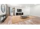 Bright living room boasts wood floors, modern decor, media center, and ample natural light for comfortable living at 4960 Malaya St, Denver, CO 80249