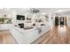 Open-concept living room with stylish fireplace, large sectional, built-ins, and natural light creating inviting, spacious feel at 4960 Malaya St, Denver, CO 80249