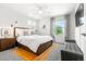 Sun-filled main bedroom featuring a wood bed frame and large windows at 4960 Malaya St, Denver, CO 80249