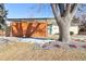 Mid-century modern home with landscaped yard at 1488 S Fairfax St, Denver, CO 80222