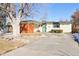 Ranch style home with landscaped yard and attached carport at 1488 S Fairfax St, Denver, CO 80222