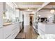 Modern kitchen with white cabinets and wood floors at 1488 S Fairfax St, Denver, CO 80222