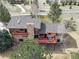 Home featuring decks and a stone chimney sits amongst lush greenery at 9745 Derby Way, Parker, CO 80134