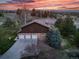 Spacious home with three-car garage, mature trees, and picturesque views at sunset at 9745 Derby Way, Parker, CO 80134