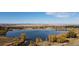 Scenic aerial view showcasing a tranquil lake surrounded by lush landscapes and mountain views at 9745 Derby Way, Parker, CO 80134