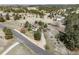 Gorgeous home aerial view with a long driveway, large lot and natural landscape including trees and hills at 9745 Derby Way, Parker, CO 80134