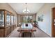 Formal dining room with a large wooden table, elegant chandelier, and backyard views at 9745 Derby Way, Parker, CO 80134
