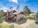 Aerial back view shows brick house with lush yard and walkout deck from second story at 9745 Derby Way, Parker, CO 80134