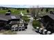 View of multiple golf carts parked outside a golf club featuring manicured fairways and lush greenery at 9745 Derby Way, Parker, CO 80134