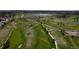 Breathtaking aerial view of an expansive golf course with rolling hills, trees, and manicured greens at 9745 Derby Way, Parker, CO 80134