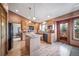 An open kitchen with hardwood floors, granite countertops, and stainless steel appliances at 9745 Derby Way, Parker, CO 80134